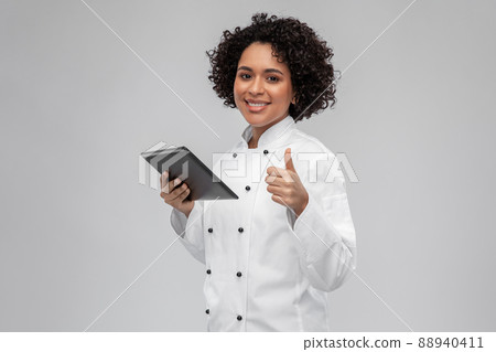 happy female chef with tablet pc showing thumbs up happy female chef with tablet pc showing thumbs up 88940411