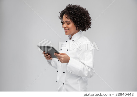 smiling female chef with tablet computer 88940448