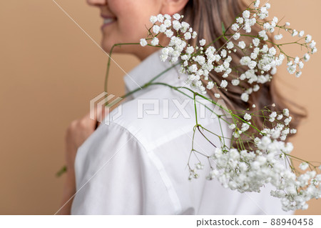 close up of woman with branch of gypsophila flower close up of woman with branch of gypsophila flower 88940458