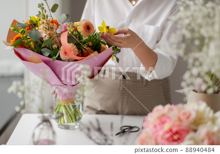 woman or floral artist with flowers at studio woman or floral artist with flowers at studio 88940484