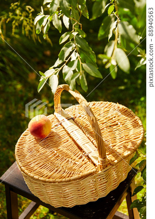 close up of picnic basket on stool in garden close up of picnic basket on stool in garden 88940563