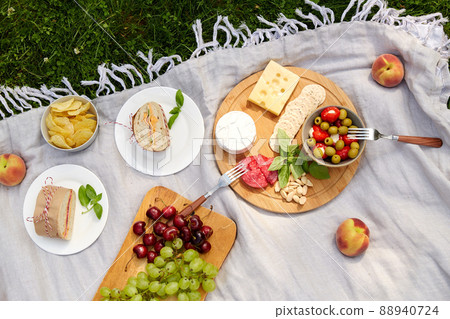 close up of food or snacks on picnic at garden 88940724