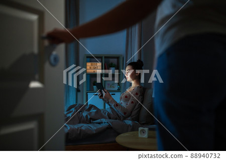 teenage girl with tablet pc in bed at night teenage girl with tablet pc in bed at night 88940732