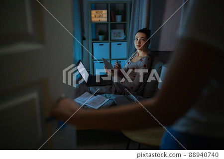 student girl with laptop learning at night 88940740