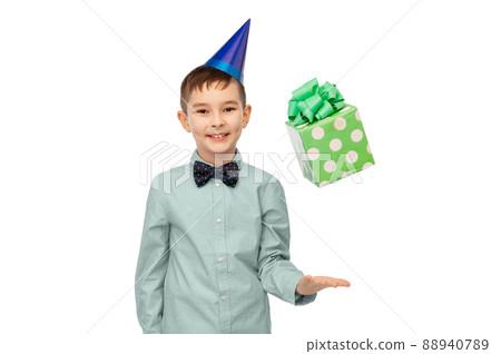 smiling boy in party hat with birthday gift 88940789