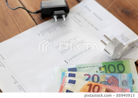 utility bill, money and electric plugs on table utility bill, money and electric plugs on table 88940913