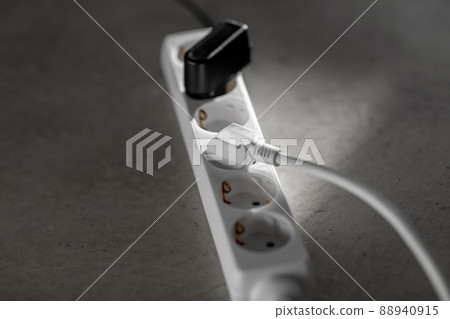close up of socket with plugs and charger on floor 88940915