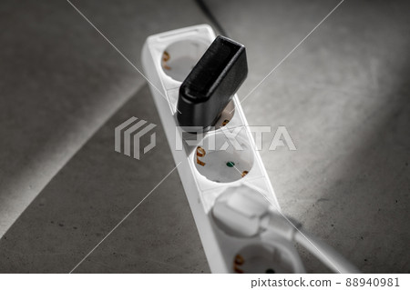 close up of socket with plugs and charger on floor close up of socket with plugs and charger on floor 88940981