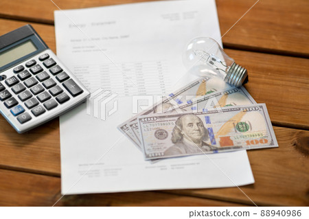 utility bill, calculator, money and lightbulb utility bill, calculator, money and lightbulb 88940986