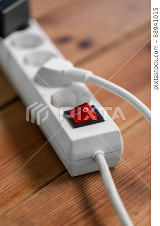 close up of socket with plugs and charger on floor close up of socket with plugs and charger on floor 88941015