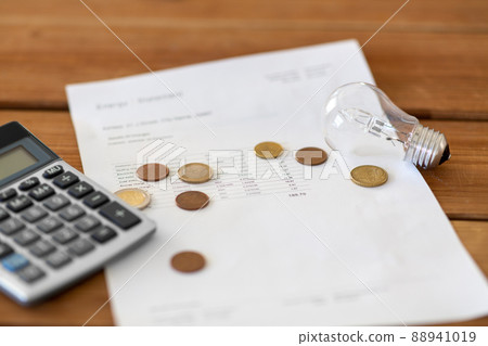 utility bill, calculator, money and lightbulb utility bill, calculator, money and lightbulb 88941019
