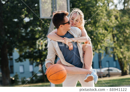 happy couple having fun on basketball playground 88941122