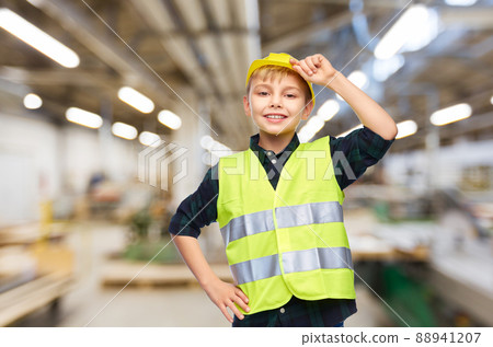 little boy in protective helmet and safety vest little boy in protective helmet and safety vest 88941207