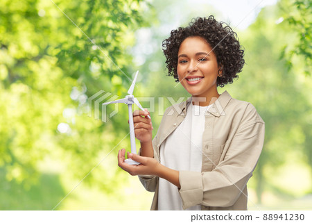 happy woman holding toy wind turbine 88941230