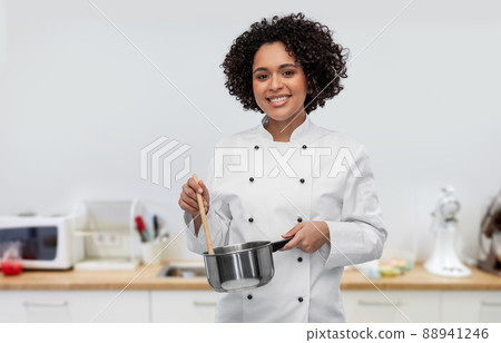 happy smiling female chef with saucepan on kitchen 88941246