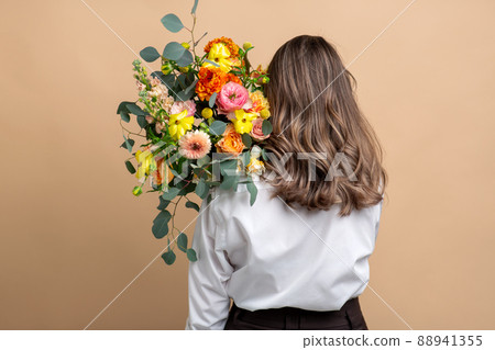 woman with bunch of flowers from back woman with bunch of flowers from back 88941355