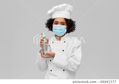 female chef in mask with hand sanitizer or soap 88941377