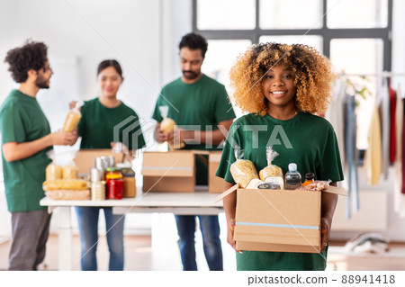 happy volunteers packing food in donation boxes 88941418
