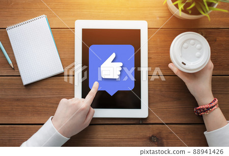 close up of hands with like icon on tablet pc close up of hands with like icon on tablet pc 88941426