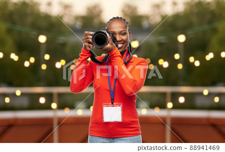 woman photographer with camera and conference id woman photographer with camera and conference id 88941469