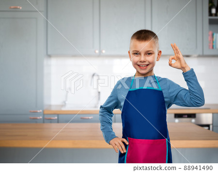 smiling little boy in apron in kitchen 88941490