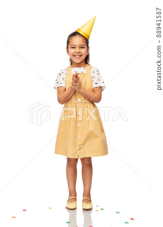 smiling little girl in birthday party hat 88941587