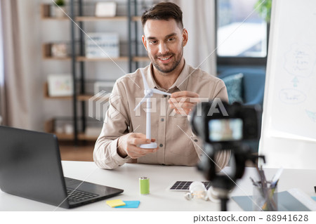 male teacher with camera and wind turbine at home 88941628