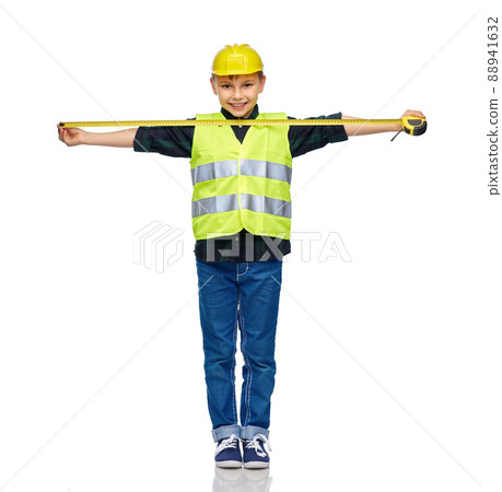 boy in construction helmet and vest with ruler boy in construction helmet and vest with ruler 88941632