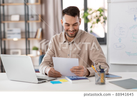 teacher with laptop and earphones working at home teacher with laptop and earphones working at home 88941645