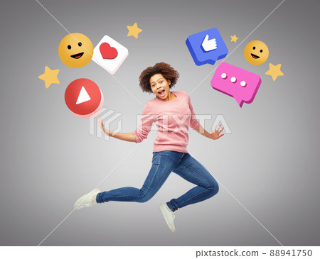 smiling young woman jumping over internet icons 88941750