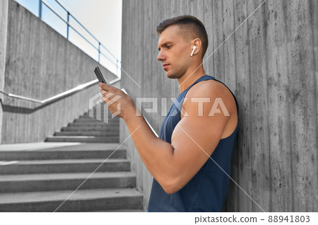 young athlete man with earphones and smartphone young athlete man with earphones and smartphone 88941803