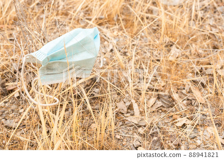 Medical mask placed on dry withered grass Medical mask placed on dry withered grass 88941821