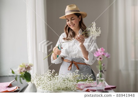 happy woman making bunch of flowers at home happy woman making bunch of flowers at home 88941948