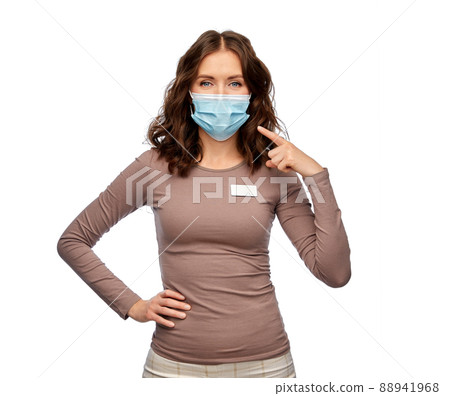 saleswoman showing medical mask on her face 88941968