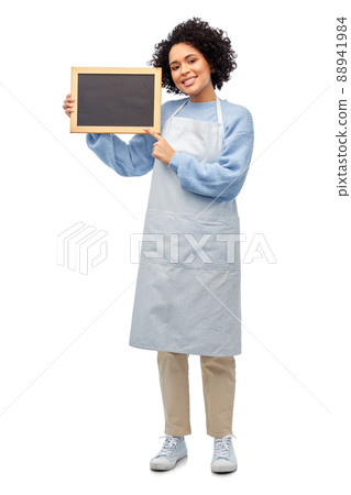 smiling woman in apron holding black chalkboard 88941984