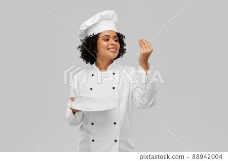 happy smiling female chef holding empty plate 88942004