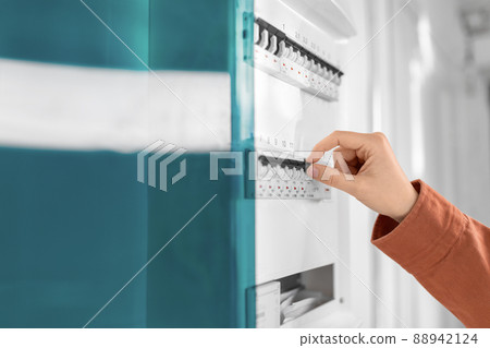 close up of hand switching electric board at home 88942124