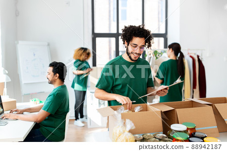group of volunteers packing food in donation boxes 88942187