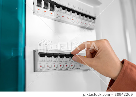 close up of hand switching electric board at home 88942269