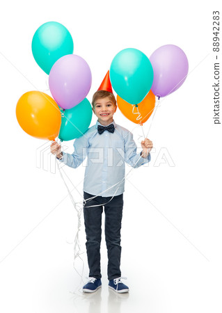 happy boy in birthday party hat with balloons happy boy in birthday party hat with balloons 88942283