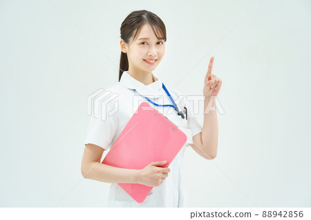 A woman in a white coat posing with her fingers raised 88942856
