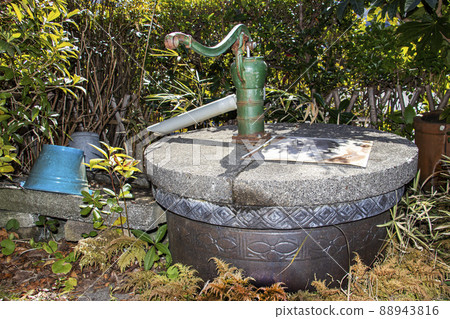 An old well and a hand pump in the garden that can be used for daily life and drinking water in the event of an emergency disaster 88943816