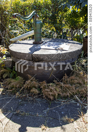 An old well and a hand pump in the garden that can be used for daily life and drinking water in the event of an emergency disaster 88943820