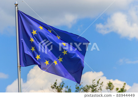 Waving flag of European Union against blue sky 88944449
