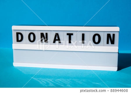 Lightbox with text DONATION. Motivational Words Quotes Concept. Colorful blue background. Minimalistic creative concept. Lightbox with text DONATION. Motivational Words Quotes Concept. Colorful blue background. Minimalistic creative concept. 88944608