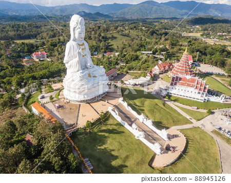 Aerial view of Big Buddha (Guan Yin Buddha) and 9 floor pagoda in Wat Huay Pla Kung temple. Tourist attraction landmark in Chiang Rai province of Thailand. Aerial view of Big Buddha (Guan Yin Buddha) and 9 floor pagoda in Wat Huay Pla Kung temple. Tourist attraction landmark in Chiang Rai province of Thailand. 88945126