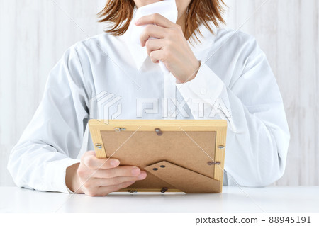 Woman crying at the photo Woman crying at the photo 88945191