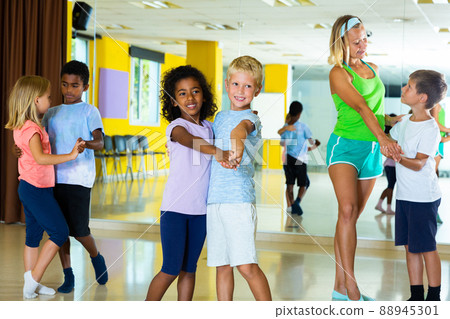 Little boys and girls dancing pair dance in the ballet studio Little boys and girls dancing pair dance in the ballet studio 88945301