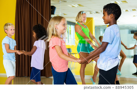 Positive little boys and girls dancing pair dance in the ballet studio Positive little boys and girls dancing pair dance in the ballet studio 88945305