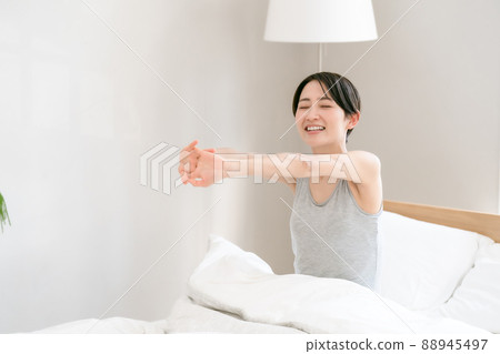 Morning awakening woman bed 88945497